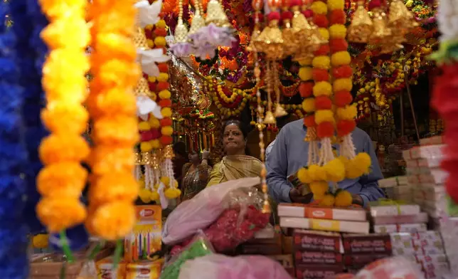 Women shop on the eve of Diwali, the Hindu festival of lights, in Jammu, India, Wednesday, Oct. 30, 2024.Diwali is one of Hinduism's most important festivals, dedicated to the worship of the goddess of wealth Lakshmi. (AP Photo/Channi Anand)