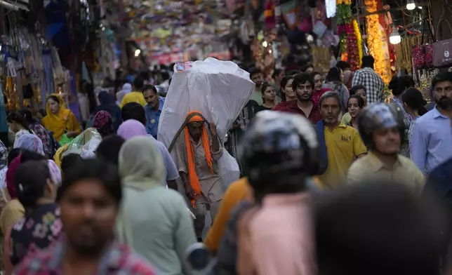 People crowd a market area on the eve of Diwali, the Hindu festival of lights, in Jammu, India, Wednesday, Oct.30,2024. Diwali is one of Hinduism's most important festivals, dedicated to the worship of the goddess of wealth Lakshmi. (AP Photo/Channi Anand)