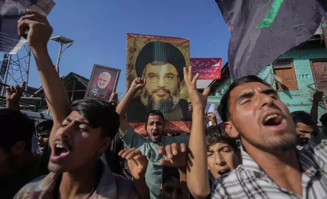 Kashmiri Shiite Muslims shout pro-Palestine and anti-Israel slogans during a protest in solidarity with Palestinians and against the killing of Hezbollah leader Hassan Nasrallah, at Mirgund north village of Srinagar, Indian controlled Kashmir, Friday, Oct. 4, 2024. (AP Photo/Mukhtar Khan)