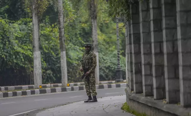 An Indian paramilitary soldier guards outside a vote counting center the recent election on the outskirts of Srinagar, Indian controlled Kashmir, Tuesday, Oct. 8, 2024. (AP Photo/Mukhtar Khan)