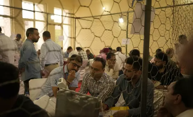 Election officers count votes for the recent election at a counting center in Jammu, India, Tuesday, Oct. 8, 2024. (AP Photo/Channi Anand)