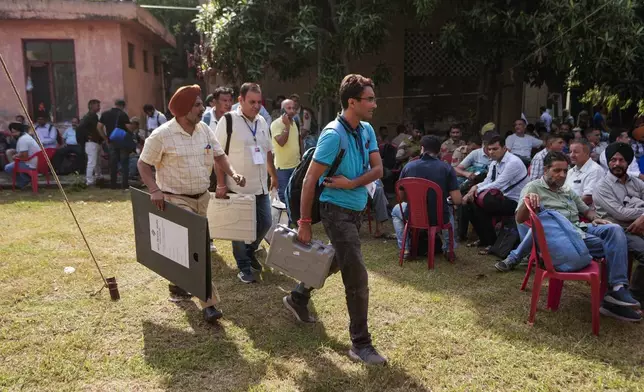 Polling officials leave for poll duty with electronic voting machines and other election material on the eve of the third phase of the Jammu and Kashmir Assembly election, in Jammu, India, Monday, Sept.30, 2024.(AP Photo/Channi Anand)