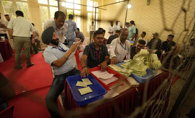 Electoral counting officials count postal ballots at a counting centre for the assembly election in Jammu, India, Tuesday, Oct. 8,2024. (AP Photo/Channi Anand)