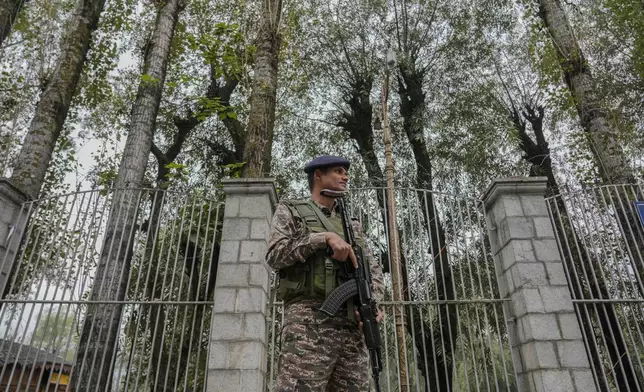 An Indian paramilitary soldier guards outside a vote counting center the recent election on the outskirts of Srinagar, Indian controlled Kashmir, Tuesday, Oct.8, 2024. (AP Photo/Mukhtar Khan)