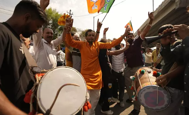 Bharatiya Janata Party (BJP) supporters dance and celebrate a party candidate's victory in Jammu, India, Tuesday, Oct.8, 2024. (AP Photo/Channi Anand)