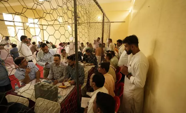 Election officers count votes for the recent election at a counting center in Jammu, India, Tuesday, Oct. 8, 2024. (AP Photo/Channi Anand)