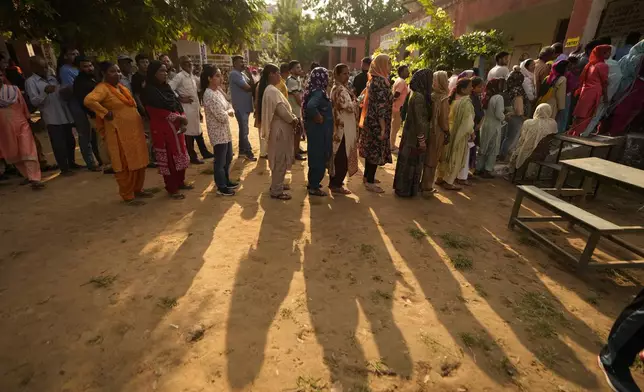 People queue up to cast their vote at a polling booth during the third phase of the Jammu and Kashmir Assembly election in Jammu, India, Tuesday, Oct. 1, 2024. (AP Photos/Channi Anand)