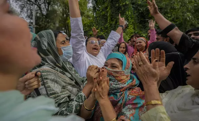 Supporters of Indian National Congress and National Conference party shout slogans as they celebrate early leads in election outside the counting center on the outskirts of Srinagar, Indian controlled Kashmir, Tuesday, Oct. 8, 2024. (AP Photo/Mukhtar Khan)