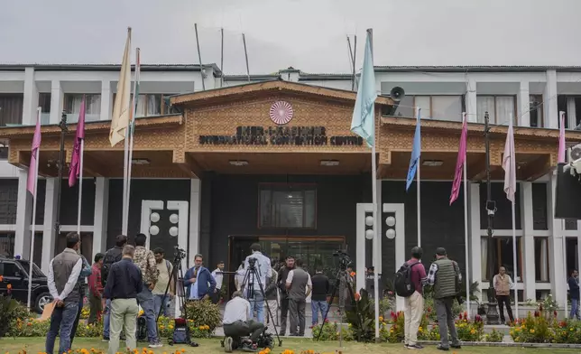 Media persons wait outside a vote counting center the recent election on the outskirts of Srinagar, Indian controlled Kashmir, Tuesday, Oct. 8, 2024. (AP Photo/Mukhtar Khan)