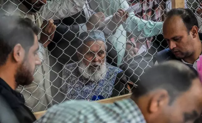 Political party representatives watch as polling officials count the votes in the recent election for a local government in Indian-controlled Kashmir on the outskirts of Srinagar, Tuesday, Oct. 8, 2024. (AP Photo/Mukhtar Khan)