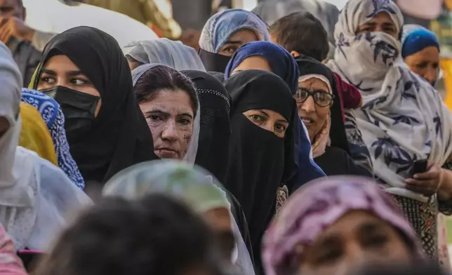 Kashmiri women queue up at a polling booth to cast their vote during the final phase of an election to choose a local government in Indian-controlled Kashmir, north of Srinagar, Tuesday, Oct.1, 2024. (AP Photo/Mukhtar Khan)