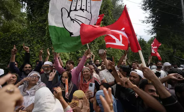 Supporters of Indian National Congress and National Conference party celebrate early leads in election outside a counting center on the outskirts of Srinagar, Indian controlled Kashmir, Tuesday, Oct. 8, 2024. (AP Photo/Mukhtar Khan)