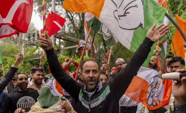 Supporters of National Conference party shout slogans as they celebrate early leads in the election for a local government in Indian controlled Kashmir, Srinagar, Tuesday, Oct. 8, 2024. (AP Photo/Dar Yasin)