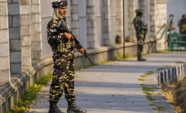 Paramilitary soldiers stand guard outside the venue of swearing in ceremony of ministers of Kashmir's local government on the outskirts of Srinagar, Indian controlled Kashmir, Wednesday, Oct. 16, 2024. (AP Photo/Dar Yasin)