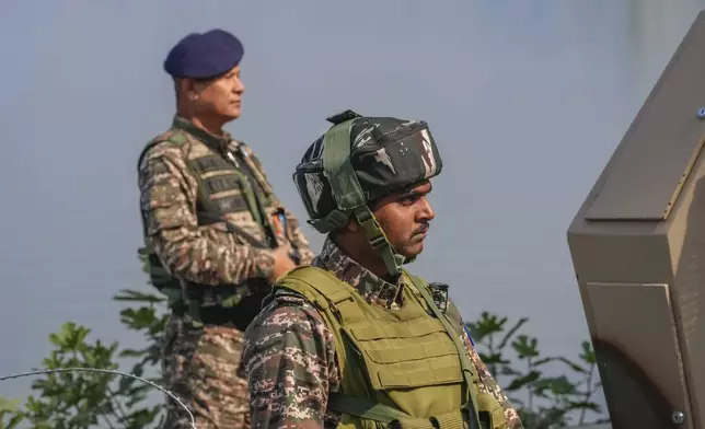 Paramilitary soldiers stand guard outside the venue of swearing in ceremony of ministers of Kashmir's local government on the outskirts of Srinagar, Indian controlled Kashmir, Wednesday, Oct. 16, 2024. (AP Photo/Dar Yasin)