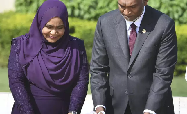 Maldives President Mohamed Muizzu along with First Lady of Maldives Sajidha Mohamed pay tributes at Rajghat, a Mahatma Gandhi memorial, in New Delhi, India, Monday, Oct. 7, 2024. (AP Photo)