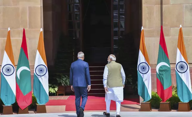 Indian Prime Minister Narendra Modi, right, walks with Maldives President Mohamed Muizzu before their delegation level meeting in New Delhi, India, Monday, Oct. 7, 2024. (AP Photo)