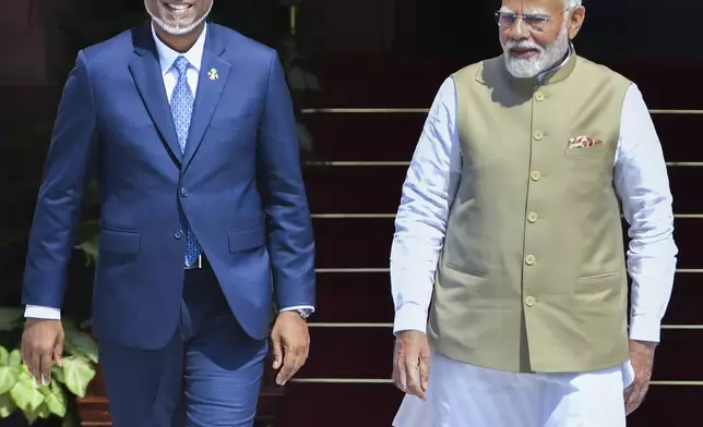 Indian Prime Minister Narendra Modi, right, walks with Maldives President Mohamed Muizzu before their delegation level meeting in New Delhi, India, Monday, Oct. 7, 2024. (AP Photo)