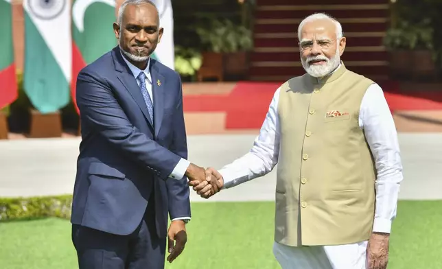 Indian Prime Minister Narendra Modi, right, and Maldives President Mohamed Muizzu shake hands before their delegation level meeting in New Delhi, India, Monday, Oct. 7, 2024. (AP Photo)