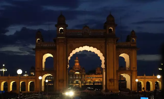 Amba Vilas Palace is lit at the twilight on the eve of final day of the Dussehra festivities, in Mysuru, India, Friday, Oct. 11, 2024. (AP Photo/Aijaz Rahi)