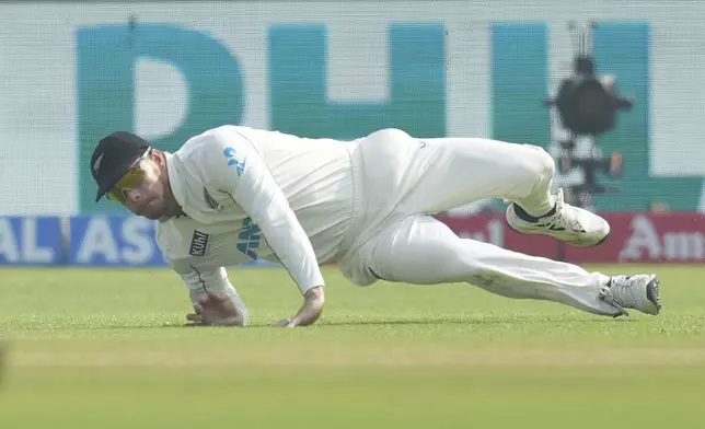 New Zealand's Glenn Philips fields the ball during the day two of the second cricket test match between India and New Zealand at the Maharashtra Cricket Association Stadium , in Pune, India, Friday, Oct. 25, 2024. (AP Photo/Rafiq Maqbool)