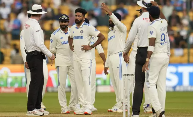 India's captain Rohit Sharma, third right, reacts after bad light stopped play on the day four of the first cricket test match between India and New Zealand at the M.Chinnaswamy Stadium, in Bengaluru, India, Saturday, Oct. 19, 2024. (AP Photo/Aijaz Rahi)