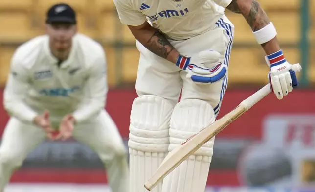 India's Virat Kohli plays a shot he is caught by New Zealand's Glenn Philips during the day two of the first cricket test match between India and New Zealand at the M.Chinnaswamy Stadium, in Bengaluru, India, Thursday, Oct. 17, 2024. (AP Photo/Aijaz Rahi)