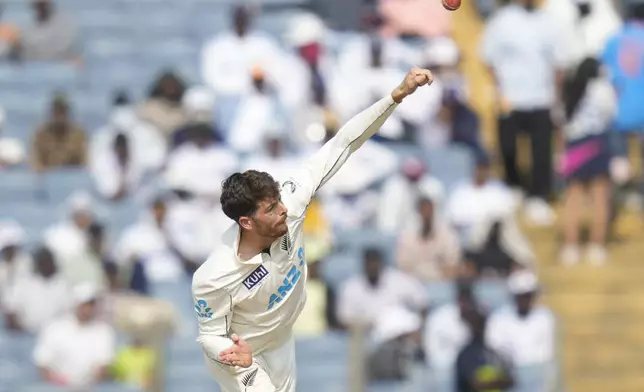 New Zealand's Mitchell Santner bowls a delivery during the day three of the second cricket test match between India and New Zealand at the Maharashtra Cricket Association Stadium , in Pune, India, Saturday, Oct. 26, 2024. (AP Photo/Rafiq Maqbool)