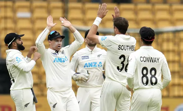 New Zealand's Tim Southee, second right, celebrates with teammates after the dismissal of India's captain Rohit Sharma during the day two of the first cricket test match between India and New Zealand at the M.Chinnaswamy Stadium, in Bengaluru, India, Thursday, Oct. 17, 2024. (AP Photo/Aijaz Rahi)