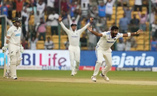 India's Jasprit Bumrah, right, appeals unsuccessfully for the wicket of New Zealand's captain Tom Latham, left, during the day four of the first cricket test match between India and New Zealand at the M.Chinnaswamy Stadium, in Bengaluru, India, Saturday, Oct. 19, 2024. (AP Photo/Aijaz Rahi)