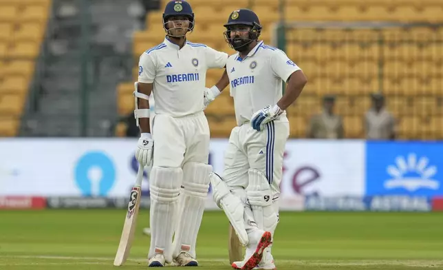 India's captain Rohit Sharma, right, and India's Yashasvi Jaiswal wait for the play to start on the day two of the first cricket test match between India and New Zealand at the M.Chinnaswamy Stadium, in Bengaluru, India, Thursday, Oct. 17, 2024. (AP Photo/Aijaz Rahi)