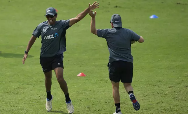 New Zealand's Rachin Ravindra, left, attends a training session ahead of their second test cricket match against India at Maharashtra Cricket Association Stadium, in Pune, India, Wednesday, Oct. 23, 2024. (AP Photo/Rafiq Maqbool)