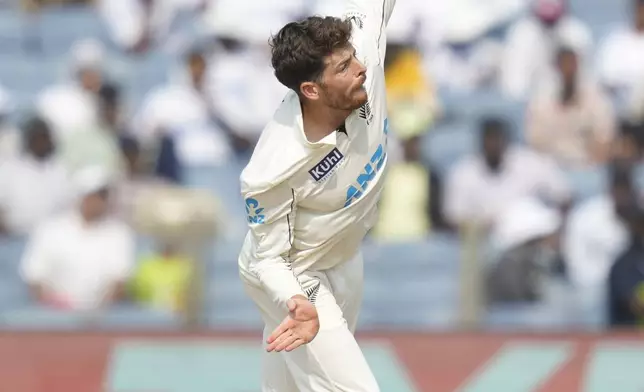 New Zealand's Mitchell Santner bowls a delivery during the day three of the second cricket test match between India and New Zealand at the Maharashtra Cricket Association Stadium , in Pune, India, Saturday, Oct. 26, 2024. (AP Photo/Rafiq Maqbool)