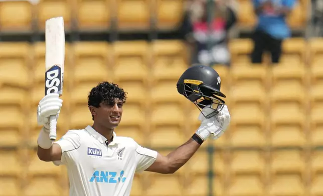 New Zealand's Rachin Ravindra celebrates after scoring a century during the day three of the first cricket test match between India and New Zealand at the M.Chinnaswamy Stadium, in Bengaluru, India, Friday, Oct. 18, 2024. (AP Photo/Aijaz Rahi)