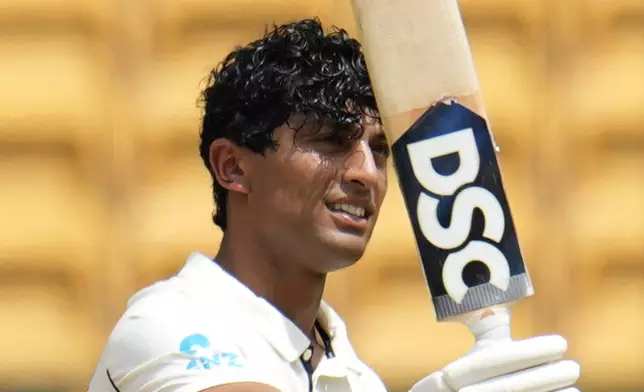 New Zealand's Rachin Ravindra celebrates after scoring a century during the day three of the first cricket test match between India and New Zealand at the M.Chinnaswamy Stadium, in Bengaluru, India, Friday, Oct. 18, 2024. (AP Photo/Aijaz Rahi)