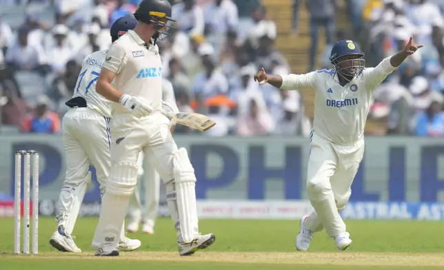 India's Sarfaraz Khan, right, appeals for the wicket of New Zealand's Will Young , left, during the day one of the second cricket test match between India and New Zealand at the Maharashtra Cricket Association Stadium , in Pune, India, Thursday, Oct. 24, 2024. (AP Photo/Rafiq Maqbool)