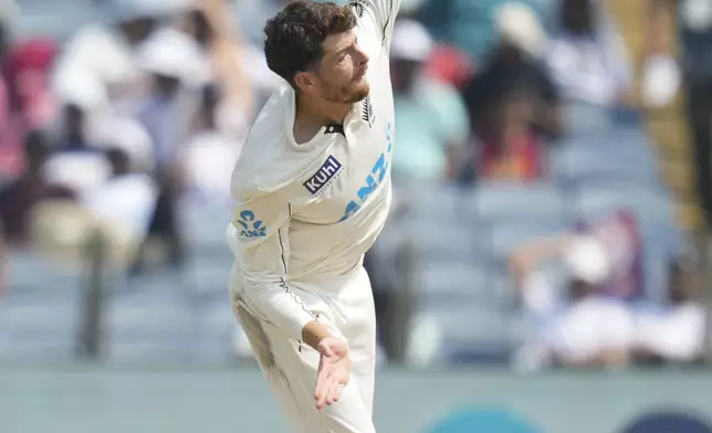 New Zealand's Mitchell Santner bowls a delivery during the day two of the second cricket test match between India and New Zealand at the Maharashtra Cricket Association Stadium , in Pune, India, Friday, Oct. 25, 2024. (AP Photo/Rafiq Maqbool)