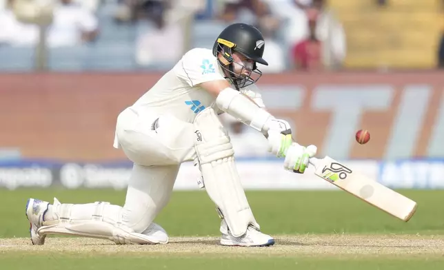 New Zealand's captain Tom Latham plays a shot during the day two of the second cricket test match between India and New Zealand at the Maharashtra Cricket Association Stadium , in Pune, India, Friday, Oct. 25, 2024. (AP Photo/Rafiq Maqbool)