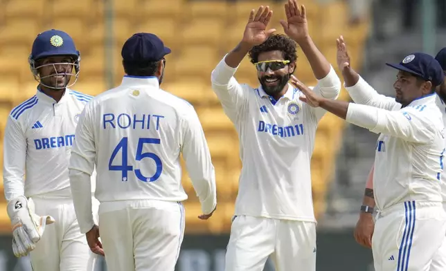 India's Ravindra Jadeja, second right, celebrates with teammates after the dismissal of New Zealand's Glenn Philips during the day three of the first cricket test match between India and New Zealand at the M.Chinnaswamy Stadium, in Bengaluru, India, Friday, Oct. 18, 2024. (AP Photo/Aijaz Rahi)