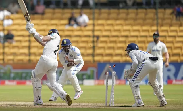 New Zealand's Matt Henry is bowled out by India's Ravindra Jadeja during the day three of the first cricket test match between India and New Zealand at the M.Chinnaswamy Stadium, in Bengaluru, India, Friday, Oct. 18, 2024. (AP Photo/Aijaz Rahi)