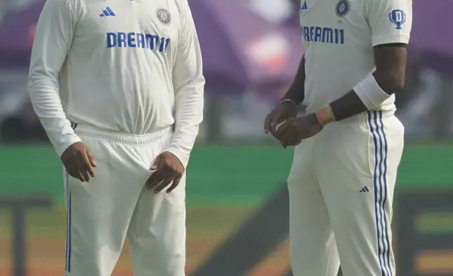 India's captain Rohit Sharma, left, chats with India's Jasprit Bumrah during the day one of the second cricket test match between India and New Zealand at the Maharashtra Cricket Association Stadium , in Pune, India, Thursday, Oct. 24, 2024. (AP Photo/Rafiq Maqbool)