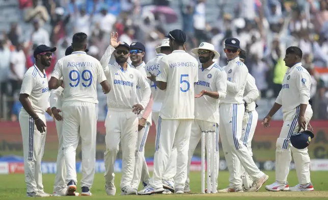 India's Ravichandran Ashwin , second from left, celebrates the dismissal of New Zealand's Will Young with his team players during the day one of the second cricket test match between India and New Zealand at the Maharashtra Cricket Association Stadium , in Pune, India, Thursday, Oct. 24, 2024. (AP Photo/Rafiq Maqbool)