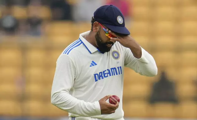 India's captain Rohit Sharma looks at the ball before passing it to his teammate Jasprit Bumrah during the day five of the first cricket test match between India and New Zealand at the M.Chinnaswamy Stadium, in Bengaluru, India, Sunday, Oct. 20, 2024. (AP Photo/Aijaz Rahi)