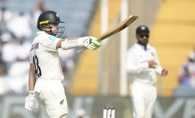 New Zealand's captain Tom Latham celebrates his fifty runs during the day two of the second cricket test match between India and New Zealand at the Maharashtra Cricket Association Stadium , in Pune, India, Friday, Oct. 25, 2024. (AP Photo/Rafiq Maqbool)