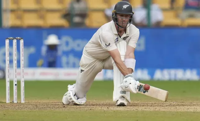 New Zealand's Will Young hits a boundary during the day five of the first cricket test match between India and New Zealand at the M.Chinnaswamy Stadium, in Bengaluru, India, Sunday, Oct. 20, 2024. (AP Photo/Aijaz Rahi)