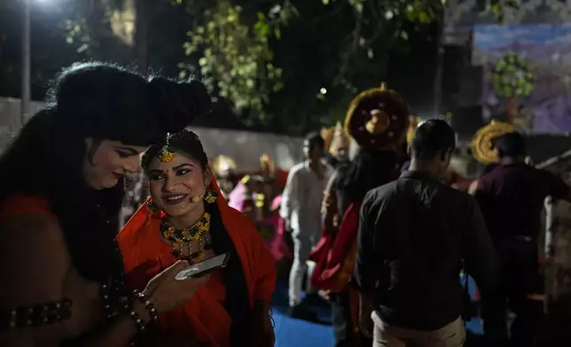 Ashutosh Agnihotri, 23, playing the character of Hindu god Rama, left, talks to Hitanshi Jha, 21, playing the character of Sita backstage during Ramleela, a dramatic folk re-enactment of the life of Rama according to the ancient Hindu epic Ramayana, in New Delhi, India, Tuesday, Oct. 8, 2024. (AP Photo/Manish Swarup)