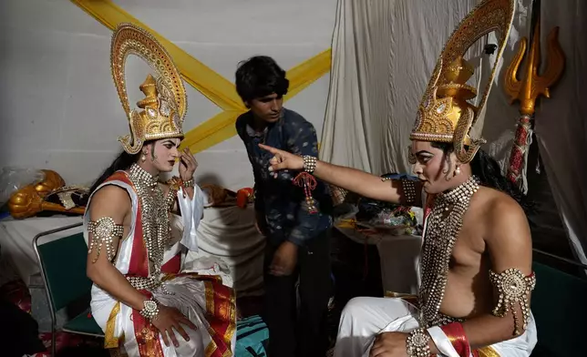 Ashutosh Agnihotri, 23, right, playing the character of Hindu god Rama, rehearses his lines backstage before the start of Ramleela, a dramatic folk re-enactment of the life of Rama according to the ancient Hindu epic Ramayana, in New Delhi, India, Saturday, Oct. 5, 2024. (AP Photo/Manish Swarup)