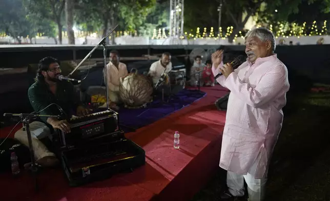 Theatre director Rakesh Ratnakar, 65, sings from the music pit during Ramleela, a dramatic folk re-enactment of the life of Hindu god Rama according to the ancient Hindu epic Ramayana, in New Delhi, India, Wednesday, Oct. 9, 2024. (AP Photo/Manish Swarup)