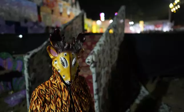 An actor dressed as a deer waits for the cue to go onstage during Ramleela, a dramatic folk re-enactment of the life of Hindu god Rama according to the ancient Hindu epic Ramayana, in New Delhi, India, Wednesday, Oct. 9, 2024. (AP Photo/Manish Swarup)