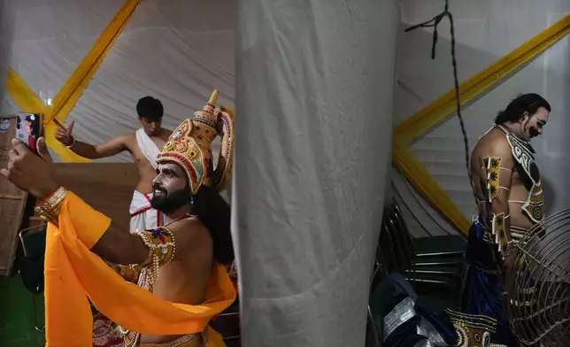 Actors rehearse their lines backstage before the start of Ramleela, a dramatic folk re-enactment of the life of Hindu god Rama according to the ancient Hindu epic Ramayana, in New Delhi, India, Saturday, Oct. 5, 2024. (AP Photo/Manish Swarup)